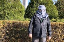 Tony with WW1 gas mask at the Brooding Soldier Canadian memorial at Vancouver Corner – Somme and Ypres WW1 Battlefield Tour
